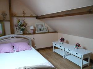 a bedroom with a white bed and a table at La grange de Candé in Monts