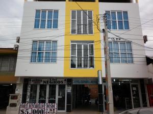 a yellow and white building on a street at Hotel Español Neiva in Neiva