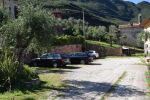 a car is parked on the side of the road at Hotel Vela Azzurra in Malcesine