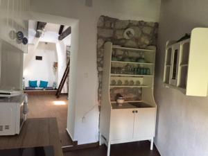 a kitchen with a white cabinet in a room at Old Town Apartment in Krk