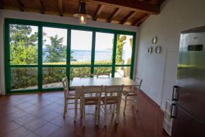a kitchen with a table and chairs and a large window at Residenza Le Sprizze in Bagno