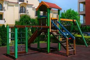 a playground with a slide in front of a building at Apart-Hotel Onegin & Thermal Zone in Sozopol +21 photos