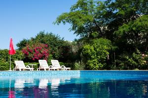 a group of chairs sitting next to a swimming pool at Apart-Hotel Onegin & Thermal Zone in Sozopol