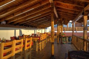 an empty restaurant with wooden tables and chairs at Casa Di Angel in Sinemorets