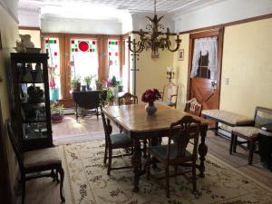 a dining room with a wooden table and chairs at Antique Rose Inn Windham in Windham