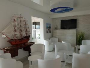 a living room with a pirate ship on the wall at Hotel Ristorante Borgo La Tana in Maratea