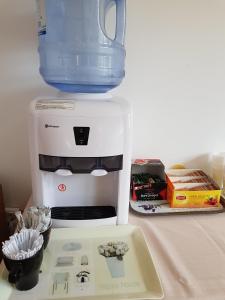 a coffee maker with a jug on top of it at Vilele Liliana in Mamaia Sat/Năvodari