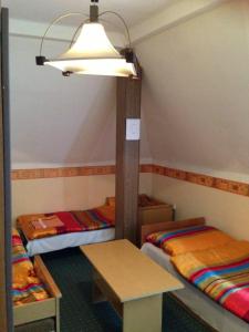 A bed or beds in a room at Panoráma Panzió