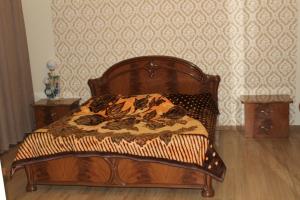a wooden bed in a room with a wall at Villa Near The Batumi in Batumi +65 photos