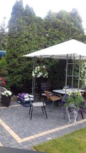 a patio with an umbrella and a table and chairs at Miramar in Łeba