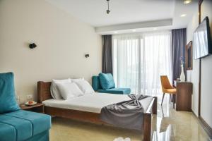 a hotel room with a bed and a couch and a room at Hotel Prova in Ulcinj