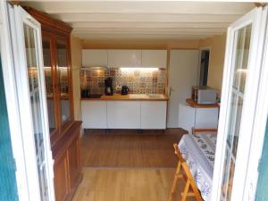 a kitchen with white cabinets and a counter top at " d'une Eure à l'autre " in Sainte-Gemme-Moronval