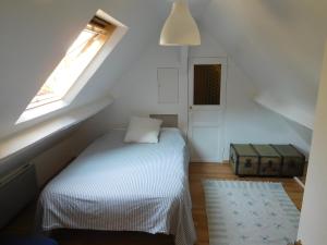 a small bedroom with a bed and a window at " d'une Eure à l'autre " in Sainte-Gemme-Moronval