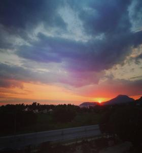 a sunset over a highway with the sun in the sky at Apartman Nina in Bar