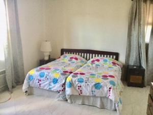 a bed with a comforter and pillows in a bedroom at Hastings Towers 3B Opp Sea 2 Bed 2 Bath in Bridgetown