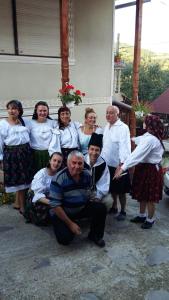 a group of people posing for a picture at Casa Ionela Petreus in Poienile Izei