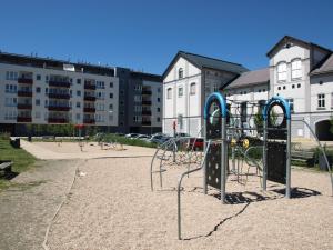 a playground in a park with buildings in the background at Apartman Self check in/out Vrchlabi in Vrchlabí