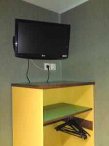 a flat screen tv sitting on top of a shelf at Hotel Siatel Metz in Norroy-le-Veneur