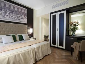 Ένα ή περισσότερα κρεβάτια σε δωμάτιο στο Ξενοδοχείο Μενελάιον