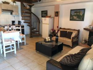 a living room with a couch and a table at Eva's House Mouresi in Mouresi