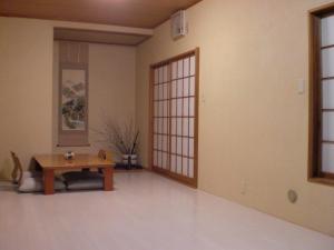 a living room with a table and a door at Numazu Ikyuuan 沼津一休庵 in Numazu