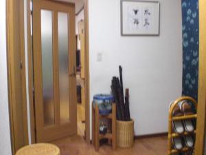 a hallway with an open door and a room with an open door at Numazu Ikyuuan 沼津一休庵 in Numazu