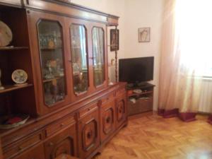 a large wooden cabinet in a living room with a television at Villa Zajednica in Ičići