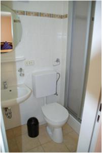 a bathroom with a white toilet and a sink at Haus Nordlicht in Helgoland