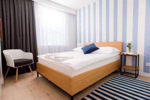Łóżko lub łóżka w pokoju w obiekcie Resort Apartamenty Klifowa Rewal 10