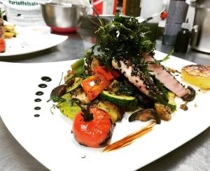 a plate of food with vegetables on a table at Lechwirt in Schongau