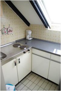 a kitchen with a sink and a counter top at Haus Nordlicht in Helgoland