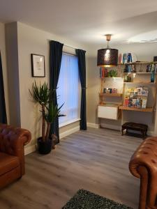a living room with a couch and a window at Spire View Townhouse in Ballycastle