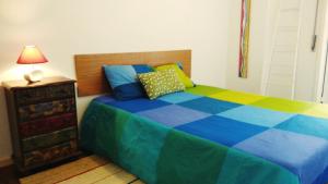 a bedroom with a colorful bed and a lamp at Walk Aveiro in Aveiro