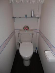 a small bathroom with a white toilet with flowers on it at Kanazawa Share House GAOoo in Kanazawa +11 photos