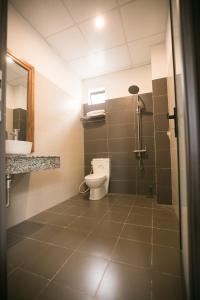a bathroom with a toilet and a sink at Yen villa Hội An in Hoi An