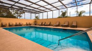 a large swimming pool with chairs at Best Western Mulberry Hotel in Mulberry