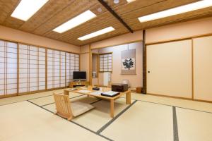 an empty room with a table and a chair at Hotel Lake View Mito in Mito