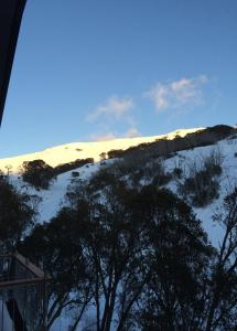 a snow covered hill with a dune in the background at Maisonette, Falls Creek in Falls Creek