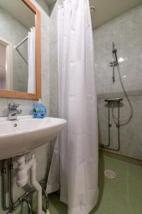 a bathroom with a shower curtain and a sink at Brålanda Hotell och Vandrarhem in Brålanda +56 photos