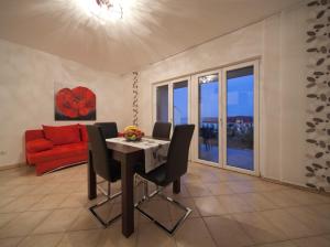 a living room with a table and a red couch at Apartments Lovely Croatia in Bol