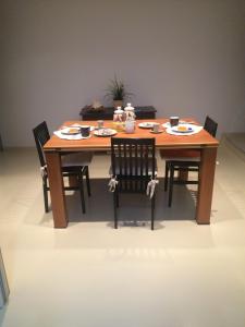 a wooden table with chairs and plates of food on it at Venetian House in Venice