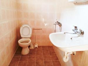 a bathroom with a toilet and a sink at Guest House Bogat-Beden in Ravda