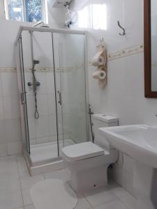 a bathroom with a shower and a toilet and a sink at Green Turaco in Zanzibar City