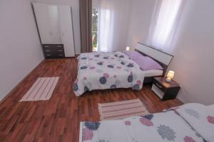 Postel nebo postele na pokoji v ubytování Apartments Alexa