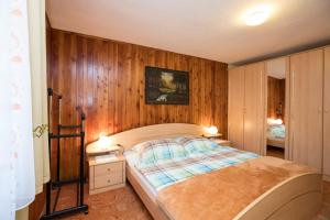 
a bedroom with a large bed and a large window at Rooms Pekovec Bohinj in Bohinj
