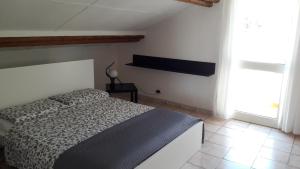 a bedroom with a bed with a black and white comforter at Casa di Caucana in Santa Croce Camerina
