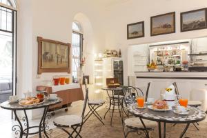 a kitchen with a table, chairs, and a table cloth at Villa Pirandello in Rome