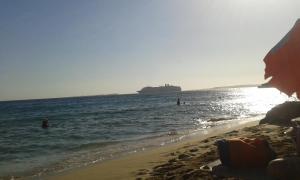 a cruise ship in the ocean with a beach at Joanna's Studios in Lassi