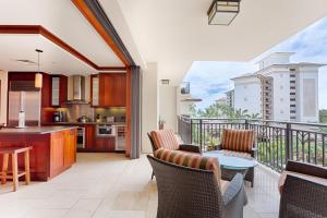 a kitchen and living room with a balcony at Spacious Fourth Floor Villa with Pool View - Ocean Tower at Ko Olina Beach Villas Resort in Kapolei