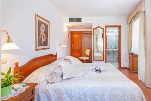 Postel nebo postele na pokoji v ubytování Hotel Ostrea